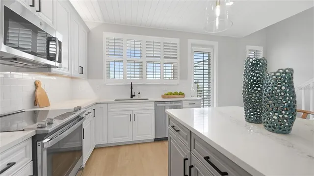 a kitchen with window cabinets and a sink