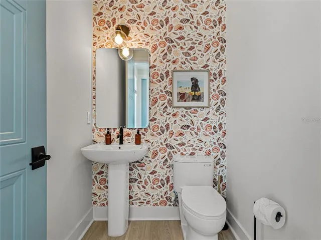 a bathroom with a sink toilet and mirror