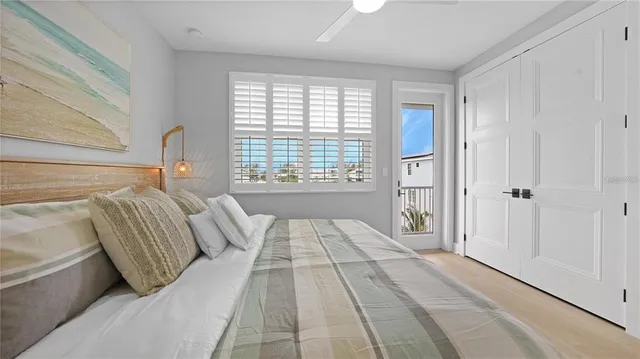 a bed room with a bed and a large window