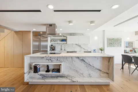 a living room with kitchen island granite countertop furniture and a fireplace
