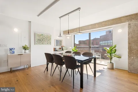 a dining room with furniture and wooden floor