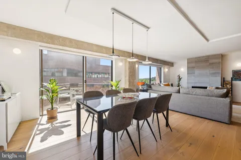 a dining room with furniture and wooden floor