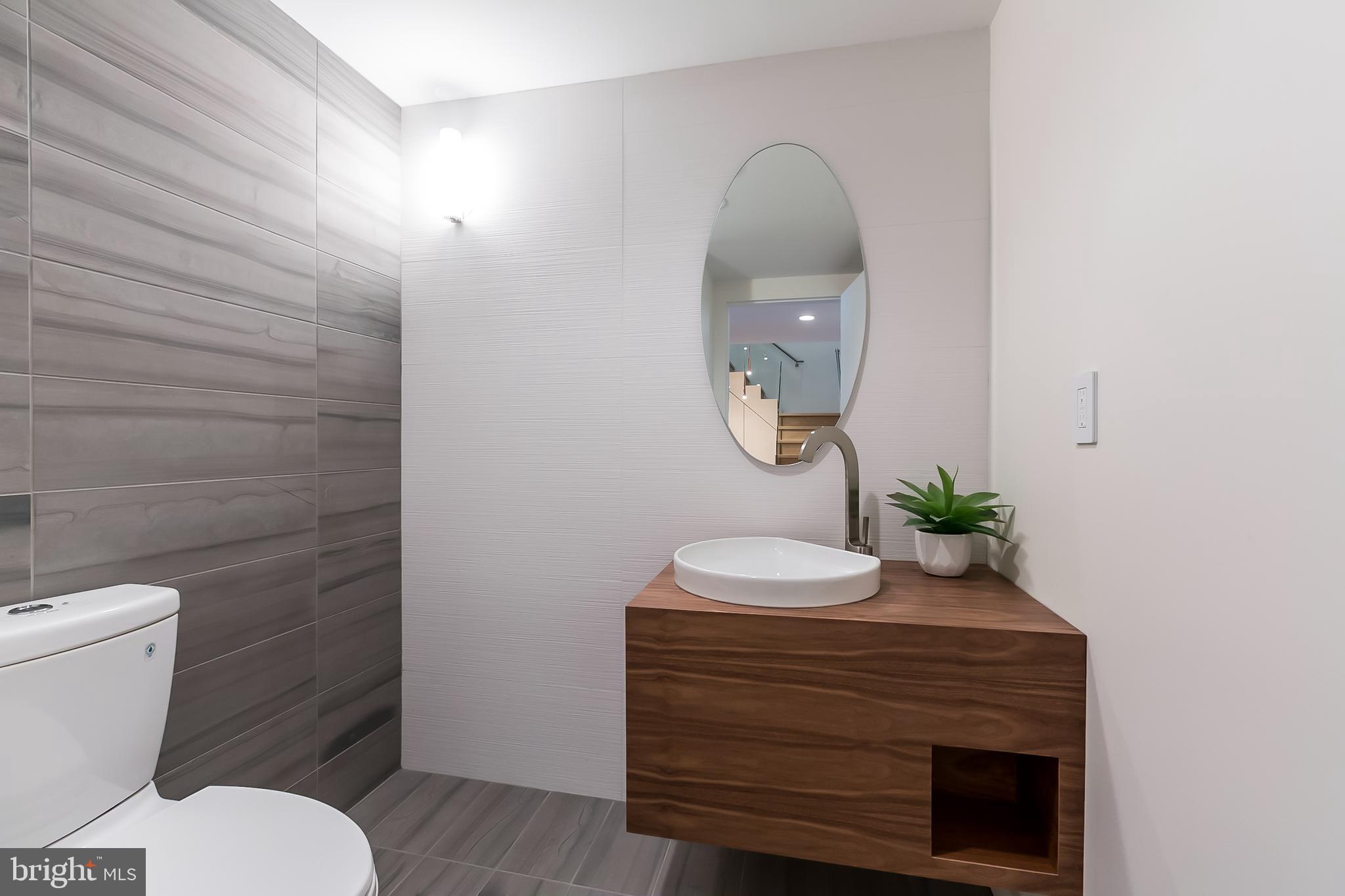 1015 33rd Street Northwest, Unit 809 Washington, DC 20007 - Photo 19 of 39 a bathroom with a sink mirror and toilet