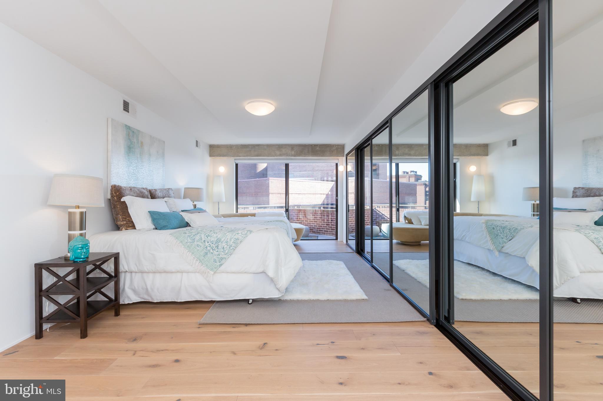 1015 33rd Street Northwest, Unit 809 Washington, DC 20007 - Photo 22 of 39 a bedroom with a large bed and a large window