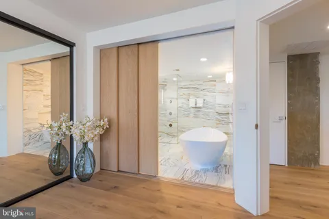 a bathroom with a double vanity sink mirror and bathtub