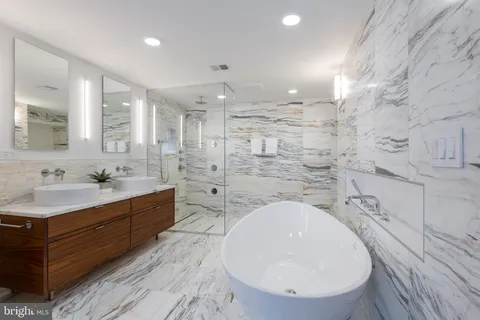 a bathroom with a shower a mirror and a sink