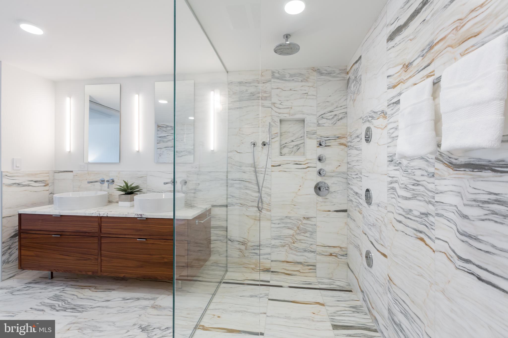 1015 33rd Street Northwest, Unit 809 Washington, DC 20007 - Photo 26 of 39 a bathroom with a shower a mirror and a sink