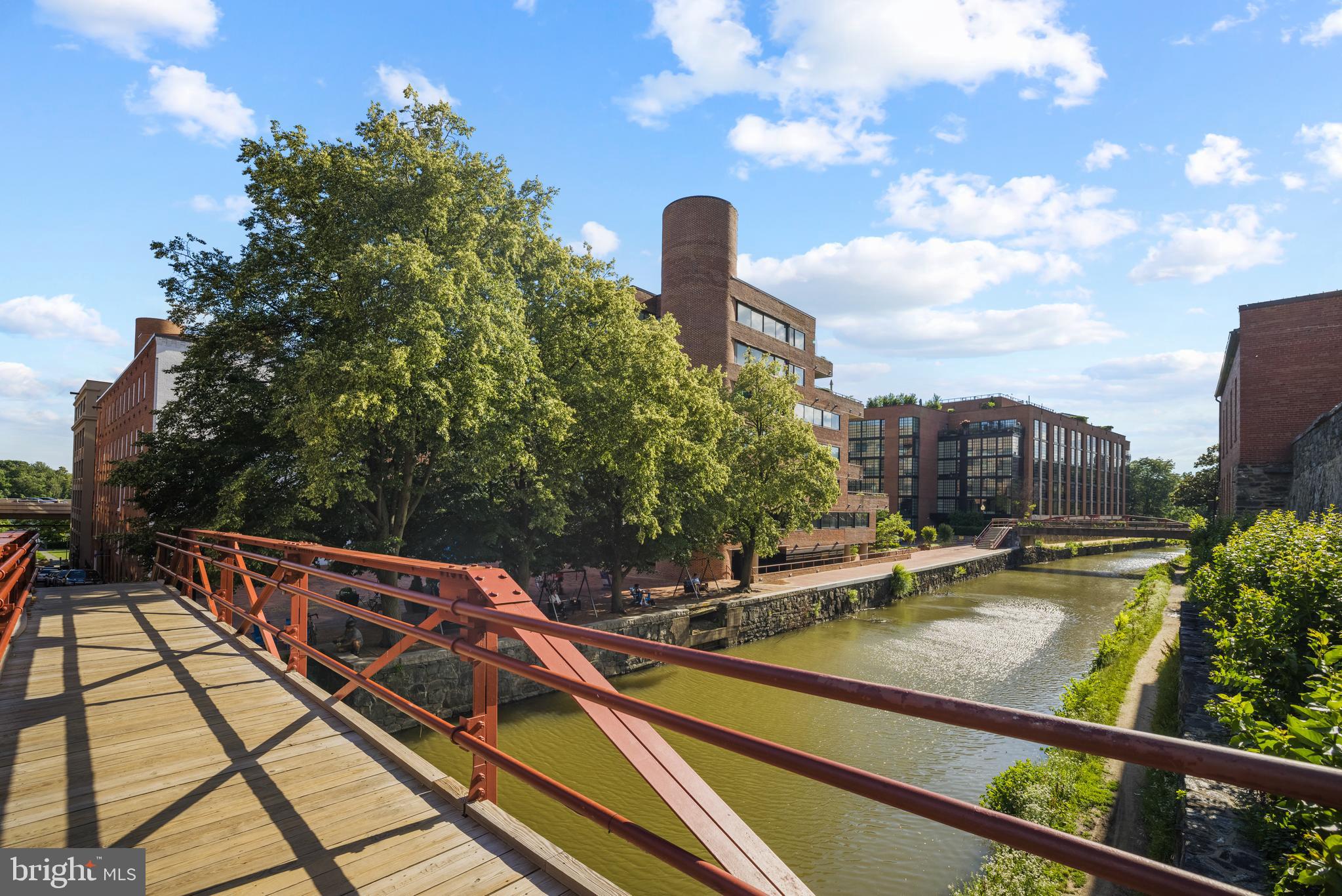 1015 33rd Street Northwest, Unit 809 Washington, DC 20007 - Photo 33 of 39 a view of swimming pool with seating space and trees in the background