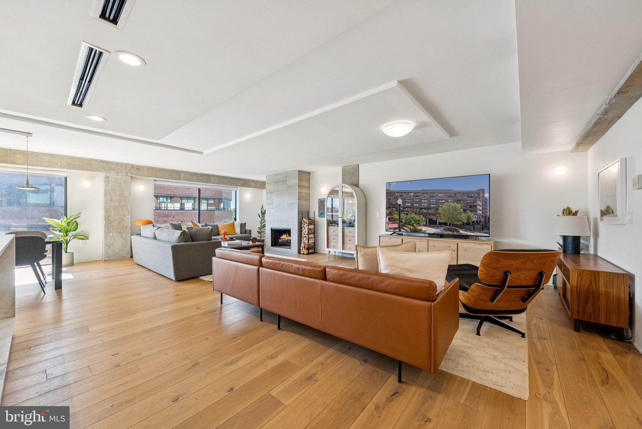 1015 33rd Street Northwest, Unit 809 Washington, DC 20007 - Photo 7 of 39 a living room with furniture and a flat screen tv