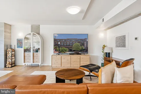 a living room with furniture a rug and a large window