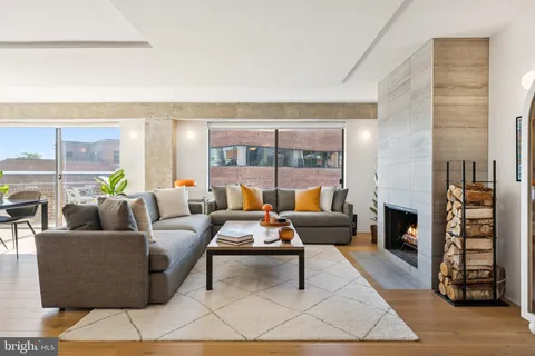 a living room with furniture and a fireplace