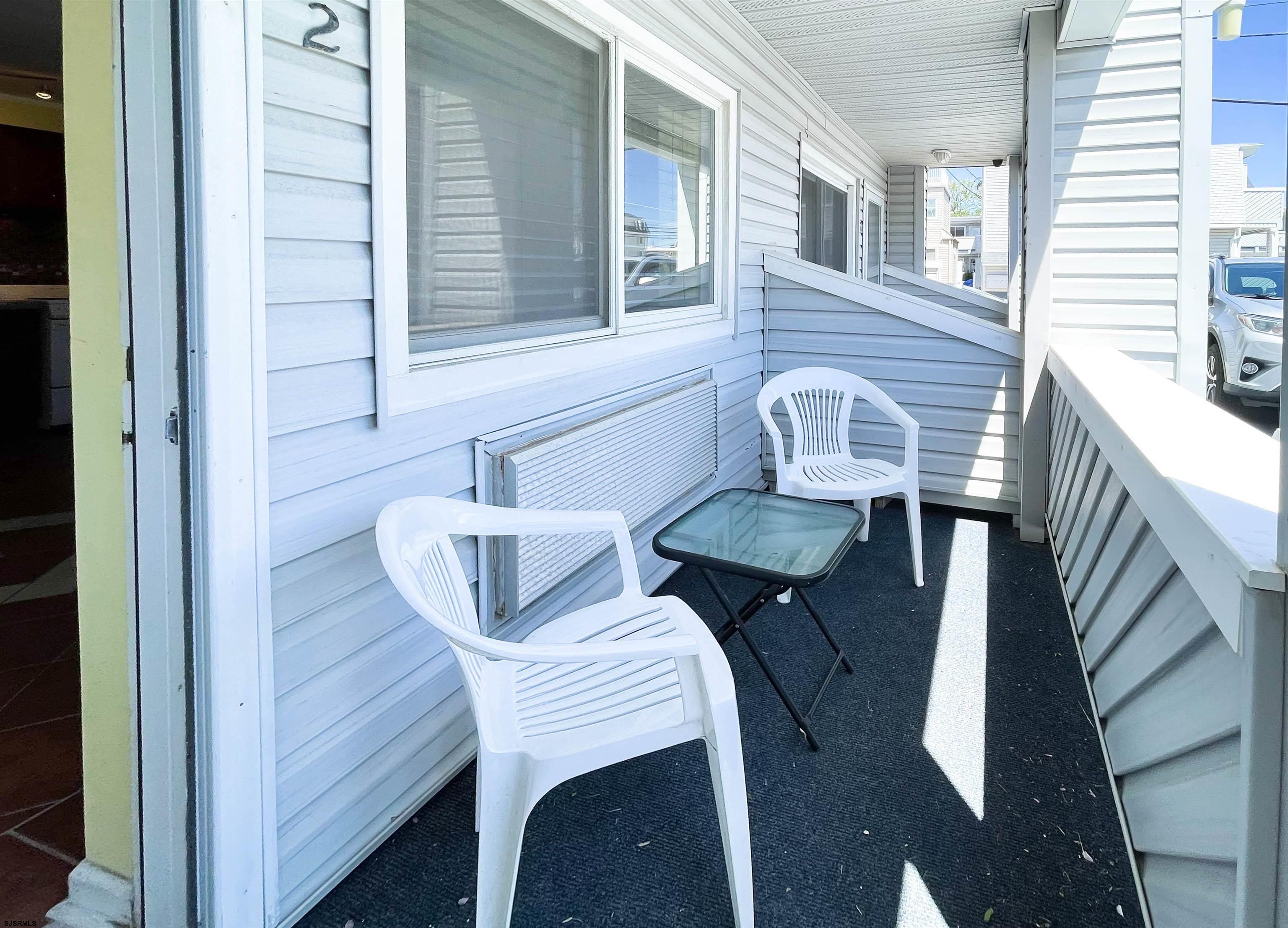 9201 Atlantic Avenue, Unit 2 Margate City, NJ 08402 - Photo 2 of 13 a balcony view with two chairs and a table