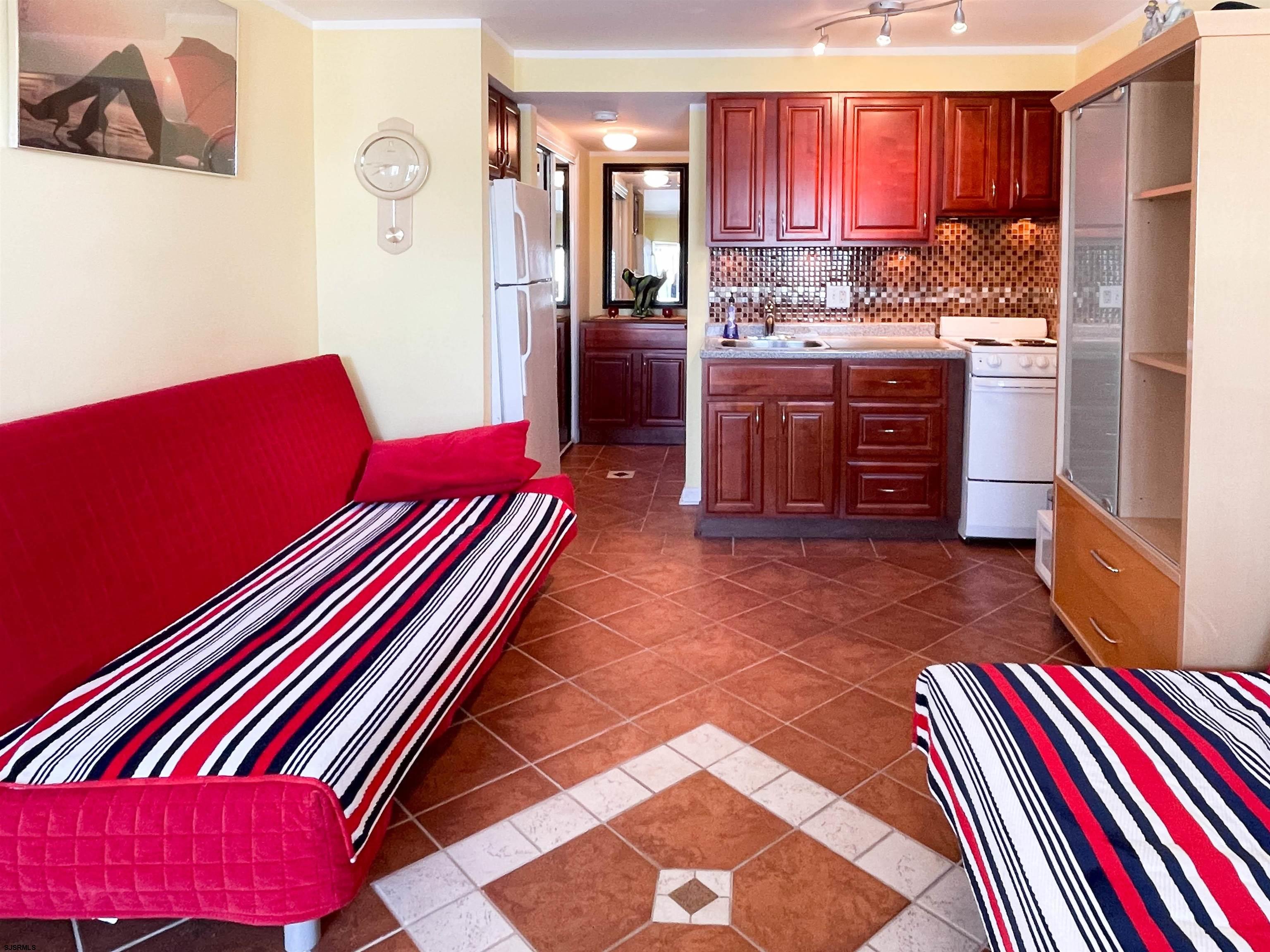 9201 Atlantic Avenue, Unit 2 Margate City, NJ 08402 - Photo 3 of 13 a kitchen with stainless steel appliances and rug