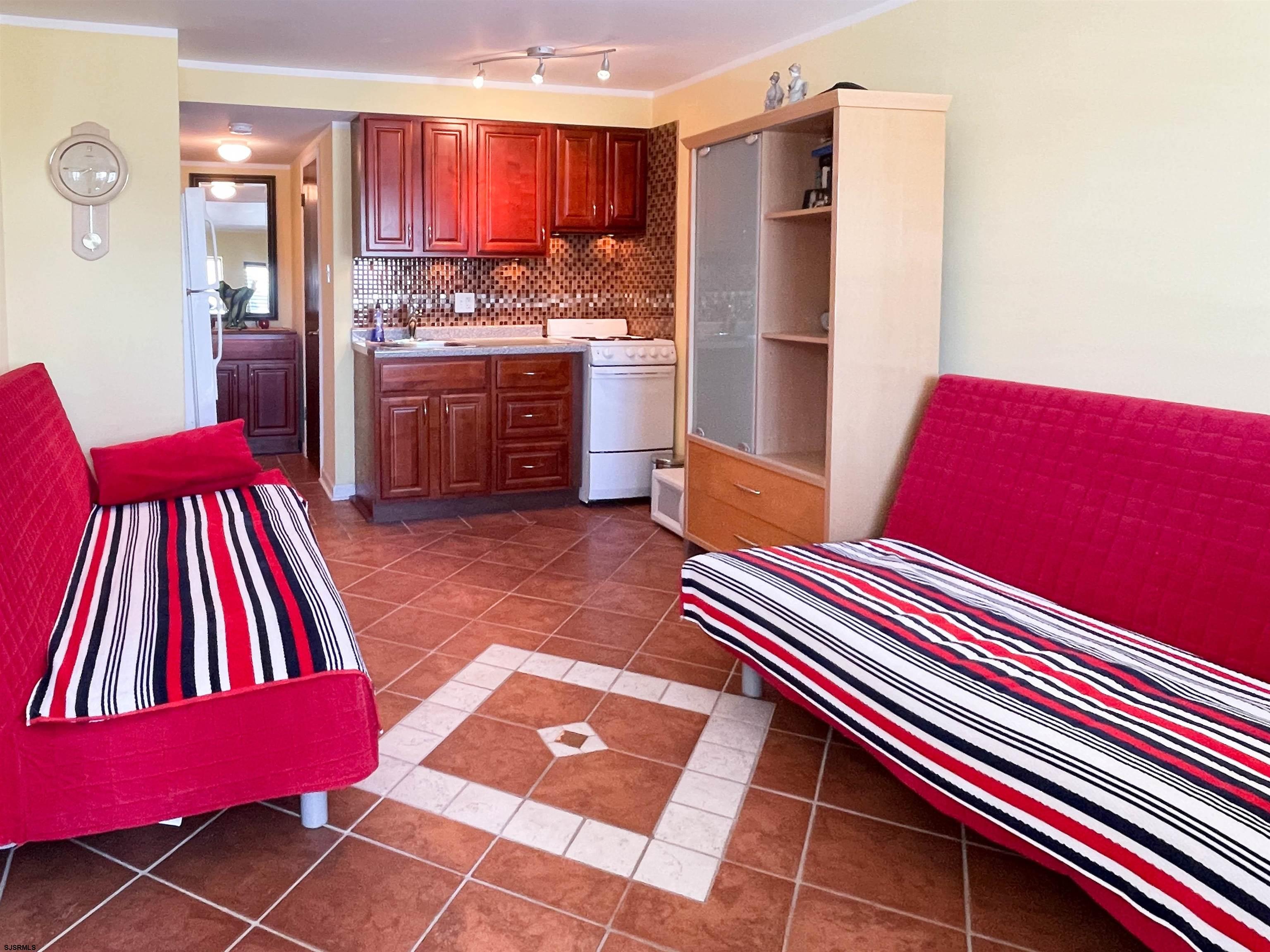 9201 Atlantic Avenue, Unit 2 Margate City, NJ 08402 - Photo 4 of 13 a kitchen with refrigerator and stove