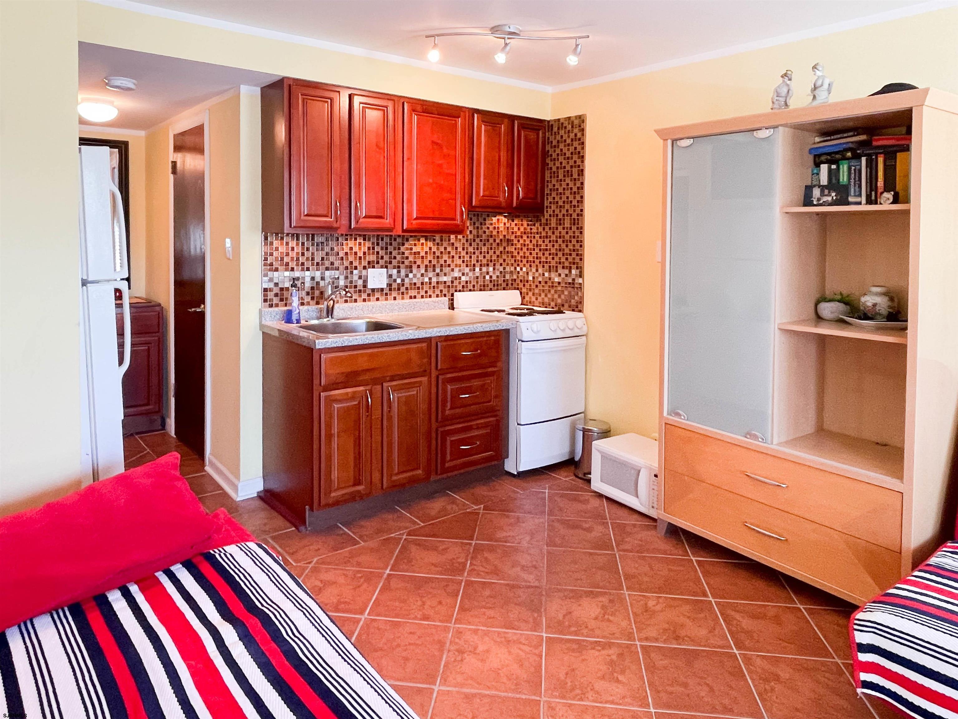 9201 Atlantic Avenue, Unit 2 Margate City, NJ 08402 - Photo 7 of 13 a kitchen with stainless steel appliances granite countertop a refrigerator and a stove