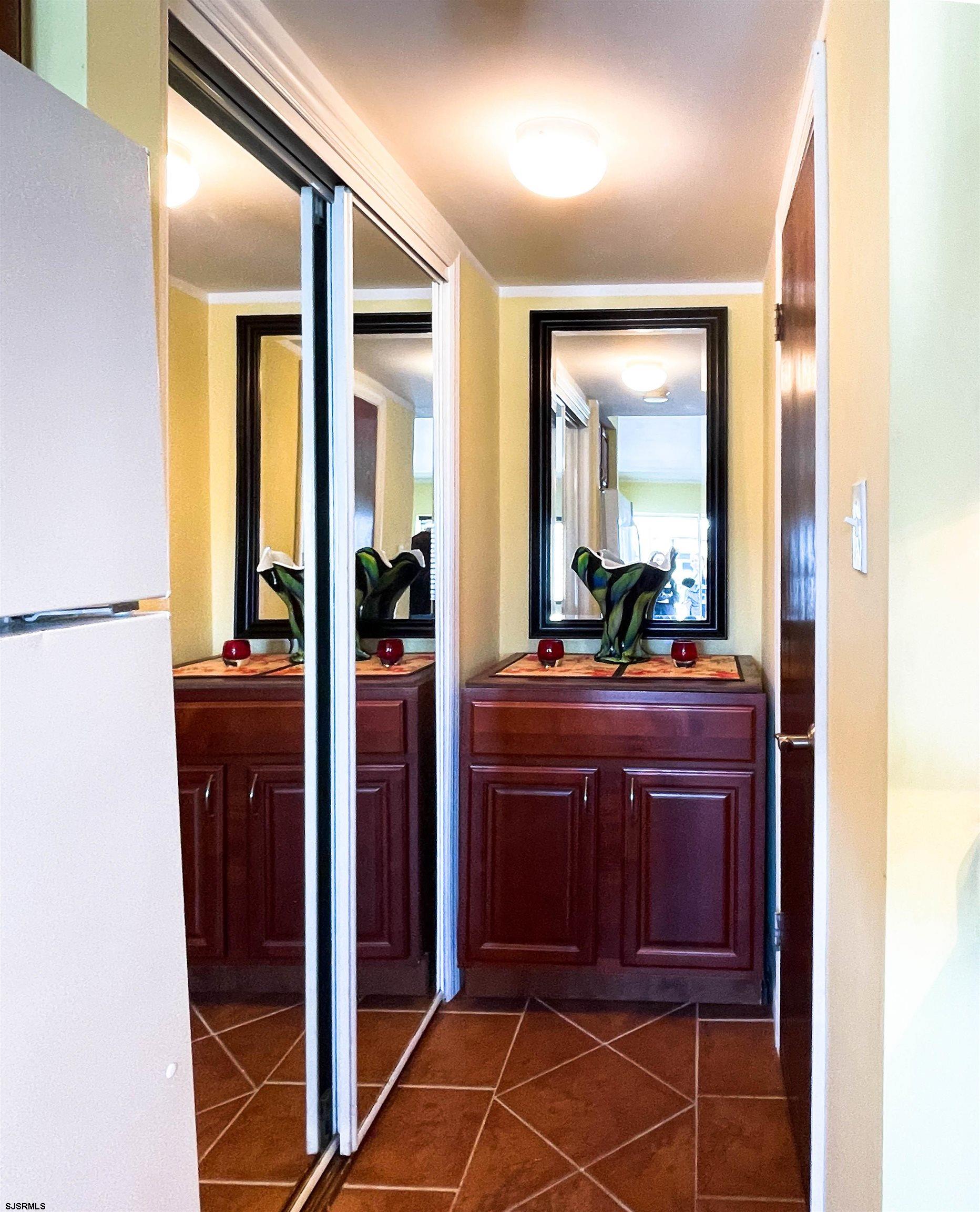 9201 Atlantic Avenue, Unit 2 Margate City, NJ 08402 - Photo 10 of 13 a view of a hallway with wooden floor and a bathroom