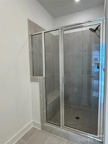 a bathroom with a glass shower door