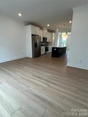 a view of kitchen with refrigerator and microwave