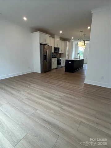 a view of kitchen with refrigerator and microwave