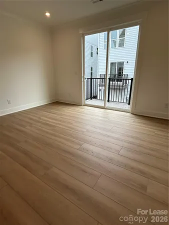 a view of an empty room with glass door