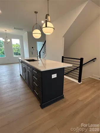 a kitchen with stainless steel appliances granite countertop a stove a sink and a wooden floors