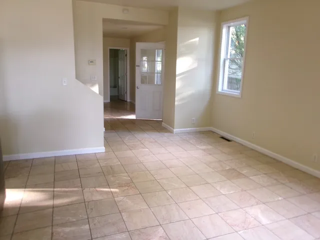 an empty room with windows and entrance