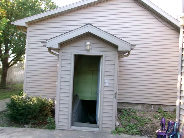 a front view of a house with plants