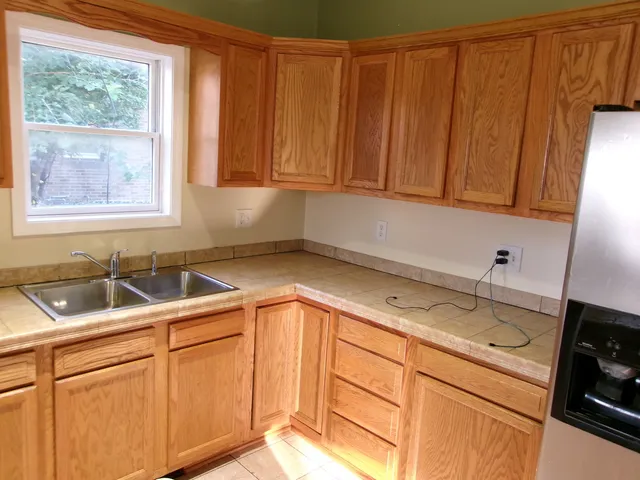 a kitchen with a sink cabinets and window