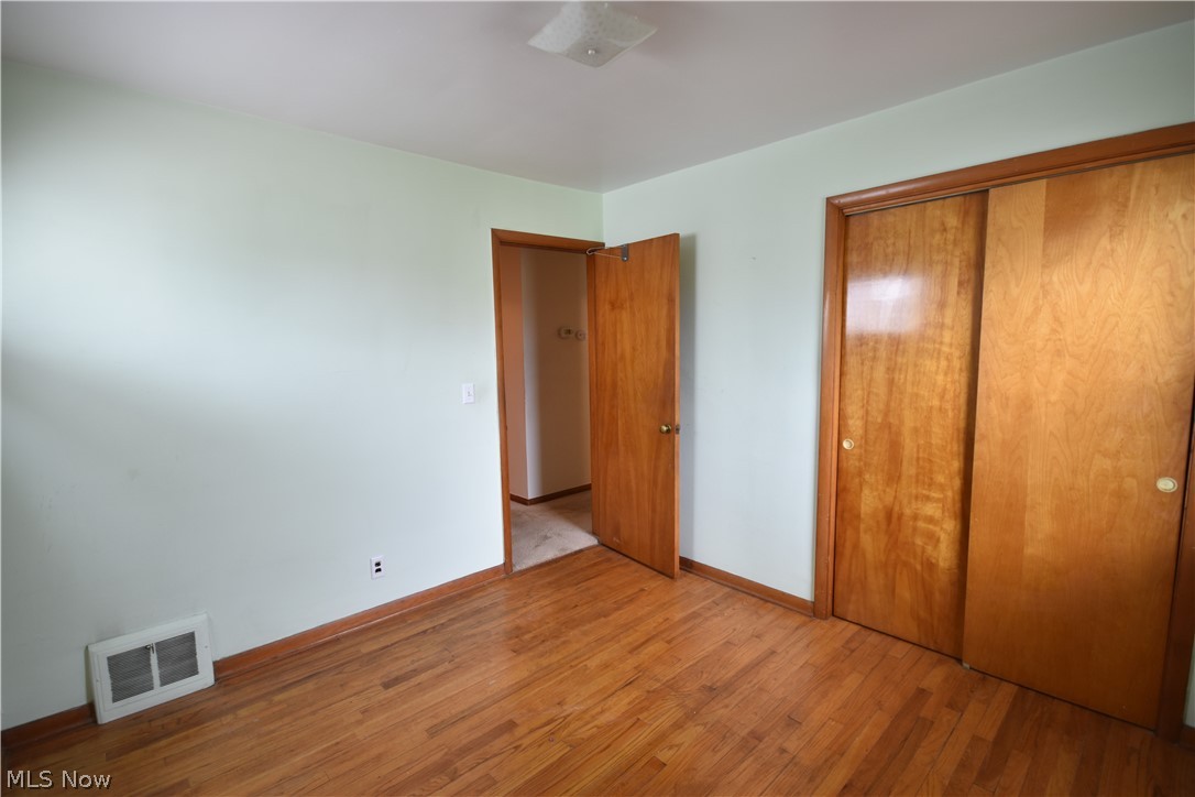 31921 Pendley Road Willowick, OH 44095 - Photo 16 of 22 Unfurnished bedroom with a closet and hardwood / wood-style floors