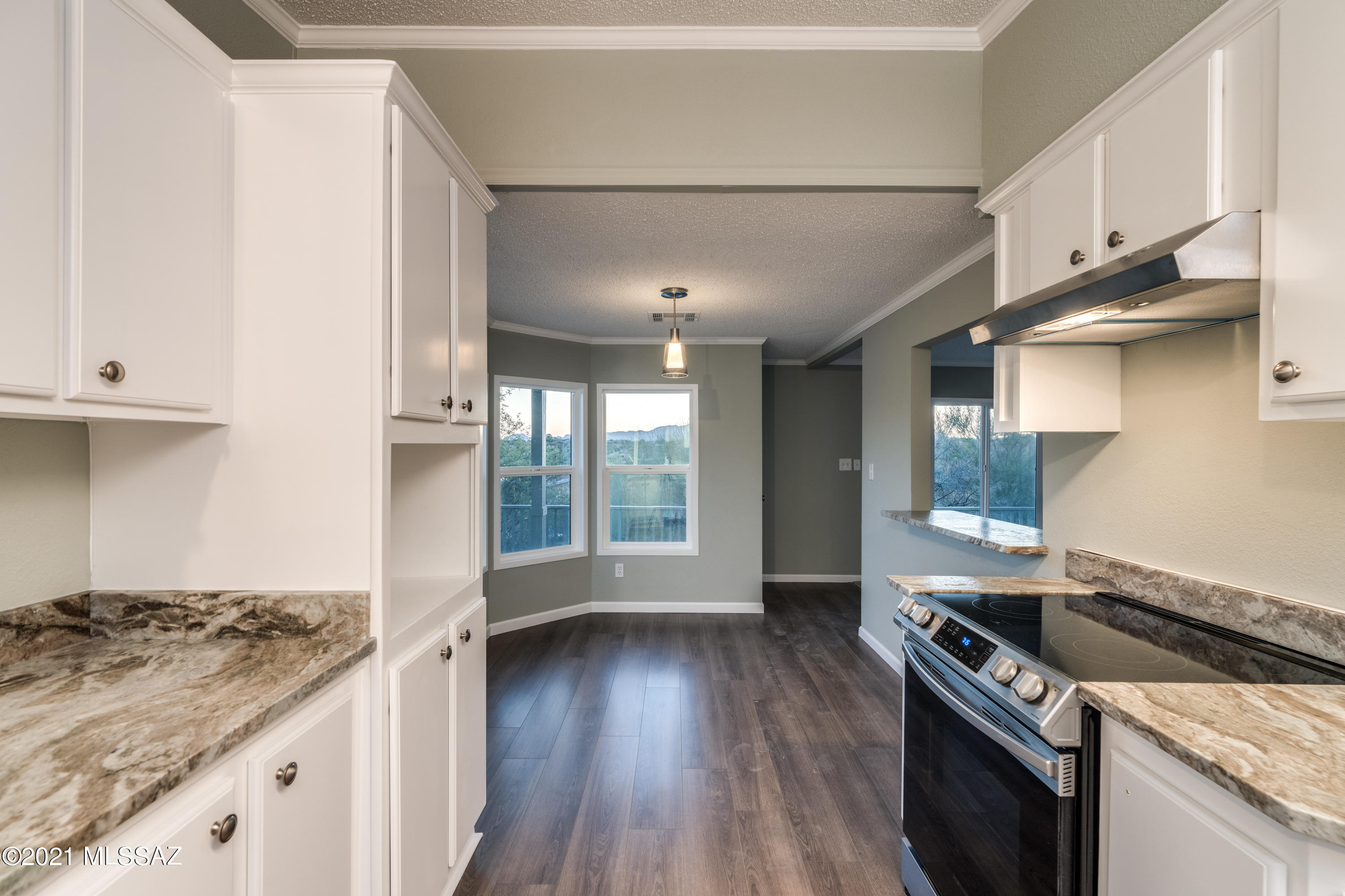 4489 East Wilds Road Tucson, AZ 85739 - Photo 22 of 50 a kitchen with granite countertop a stove and a sink