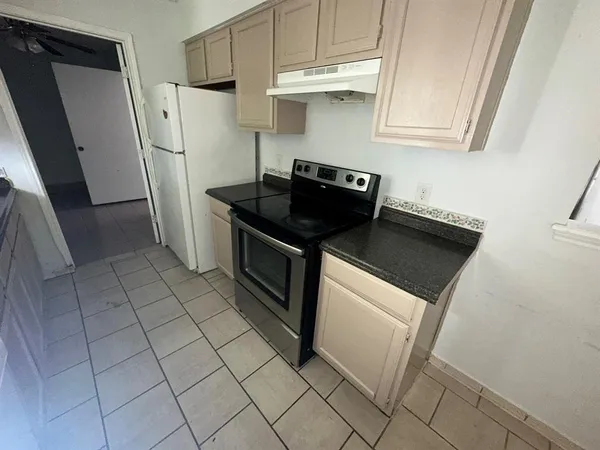 a kitchen with stainless steel appliances a stove a refrigerator and cabinets