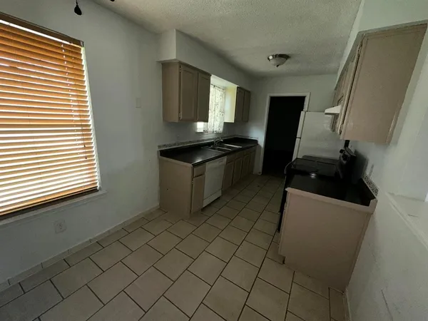 a kitchen with a sink and a stove top oven