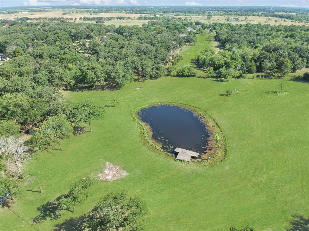 1001 Sandy Ridge Road Scurry, TX 75158 - Photo 7 of 35 Expansive green landscape featuring a central pond with a wooden dock