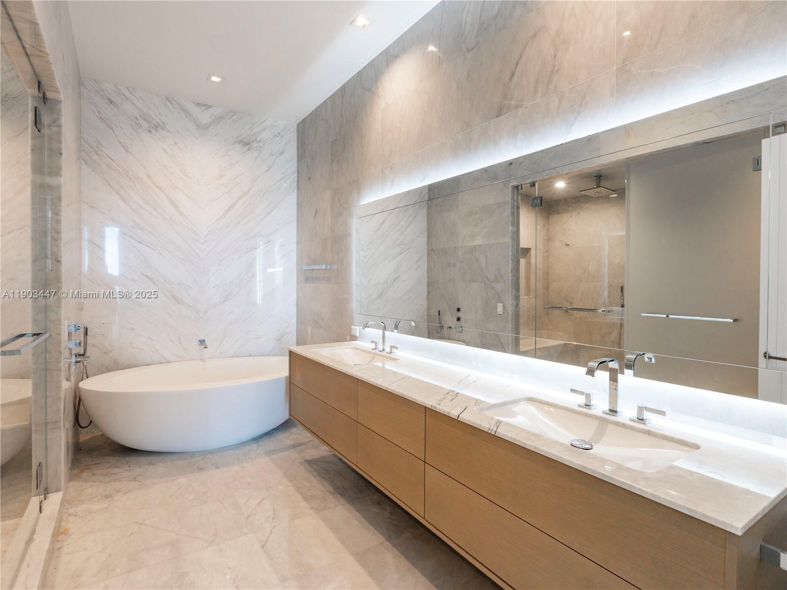 18501 Collins Avenue, Unit 1501 Sunny Isles Beach, FL 33160 - Photo 11 of 35 a spacious bathroom with a double vanity sink mirror and bathtub