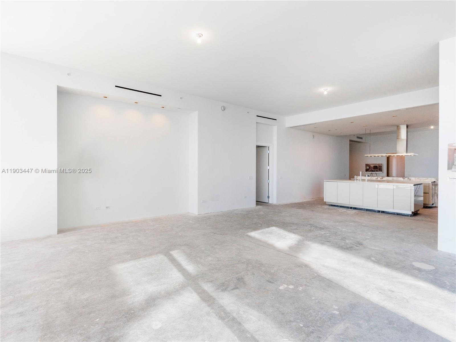 18501 Collins Avenue, Unit 1501 Sunny Isles Beach, FL 33160 - Photo 13 of 35 a spacious bedroom with a bed and a chandelier