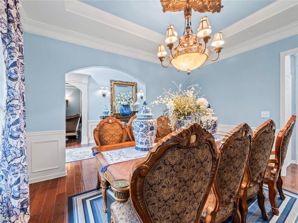 7060 Summit Ridge Chase Cumming, GA 30041 - Photo 16 of 58 a view of a dining room with furniture and wooden floor