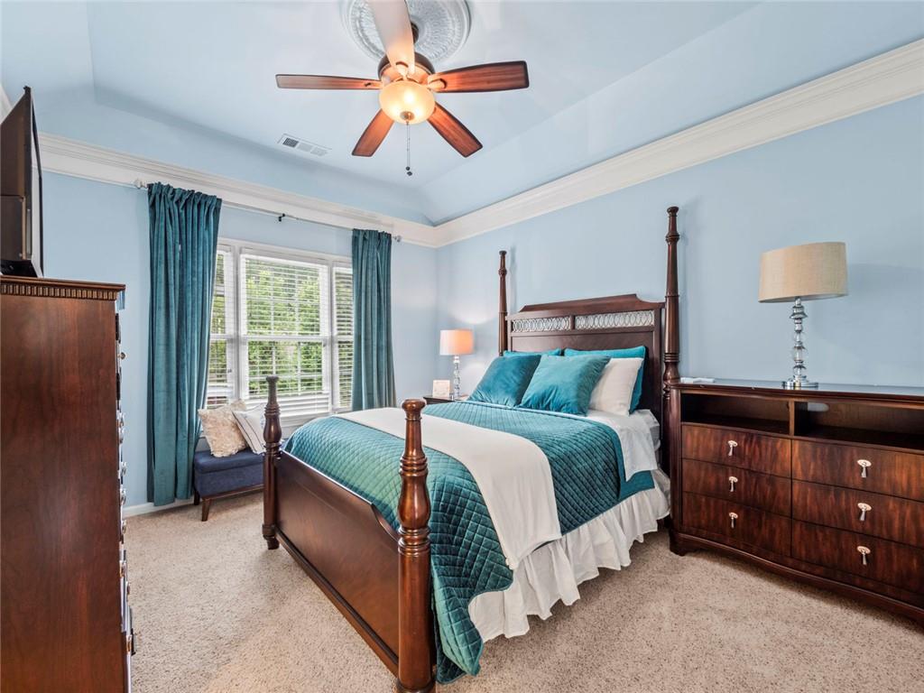 7060 Summit Ridge Chase Cumming, GA 30041 - Photo 18 of 58 a bed room with a bed and a lamp