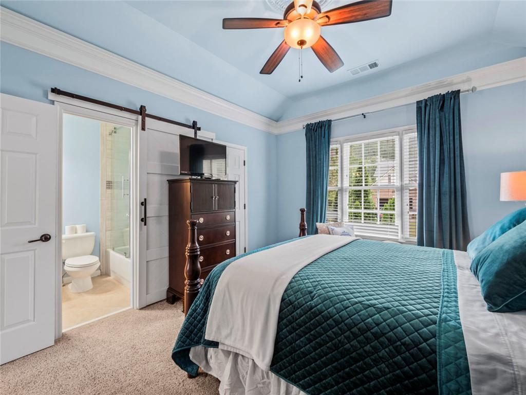 7060 Summit Ridge Chase Cumming, GA 30041 - Photo 19 of 58 a bedroom with a bed and a walk in closet