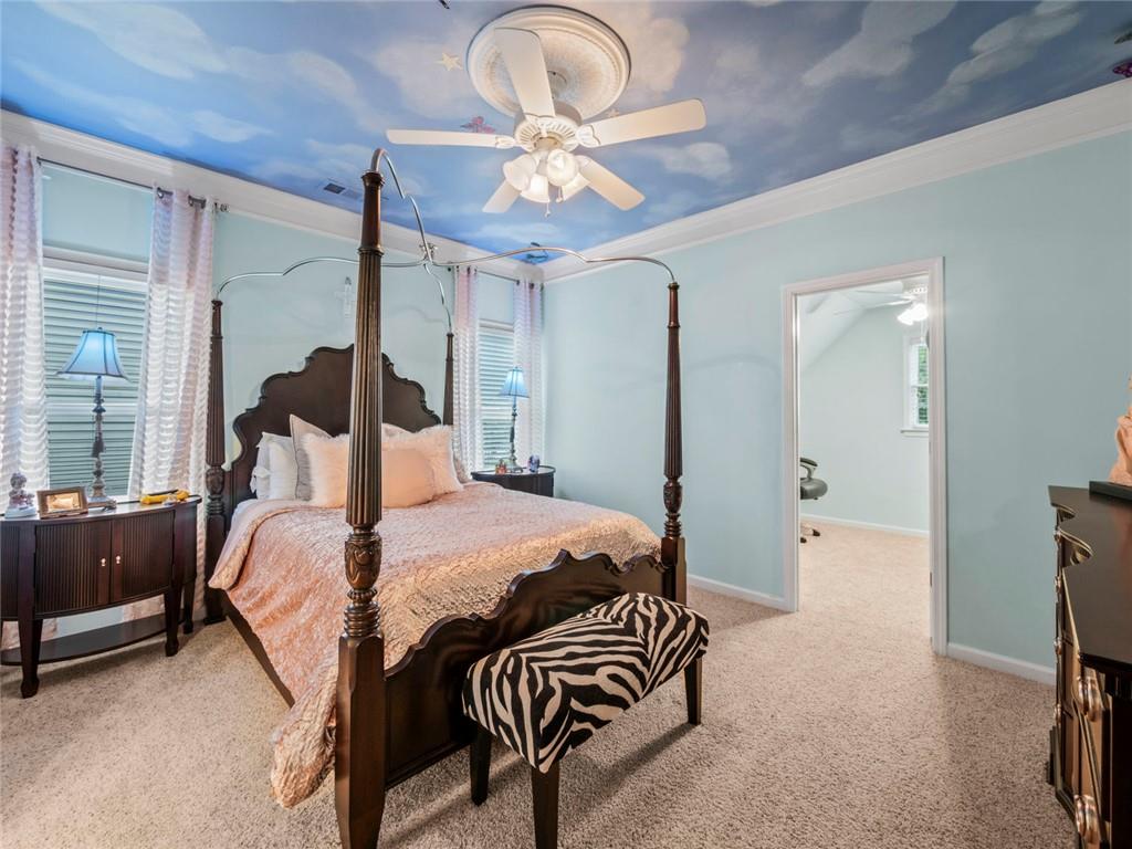 7060 Summit Ridge Chase Cumming, GA 30041 - Photo 21 of 58 a bedroom with a bed and a chandelier