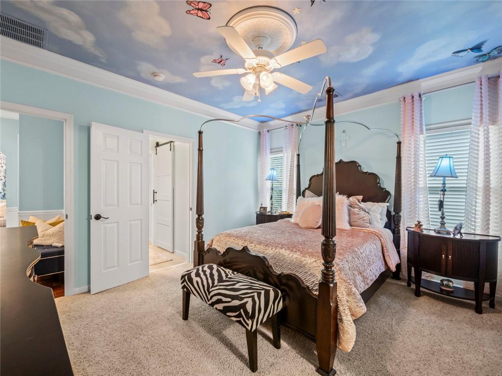 7060 Summit Ridge Chase Cumming, GA 30041 - Photo 22 of 58 a bedroom with a bed and a chandelier