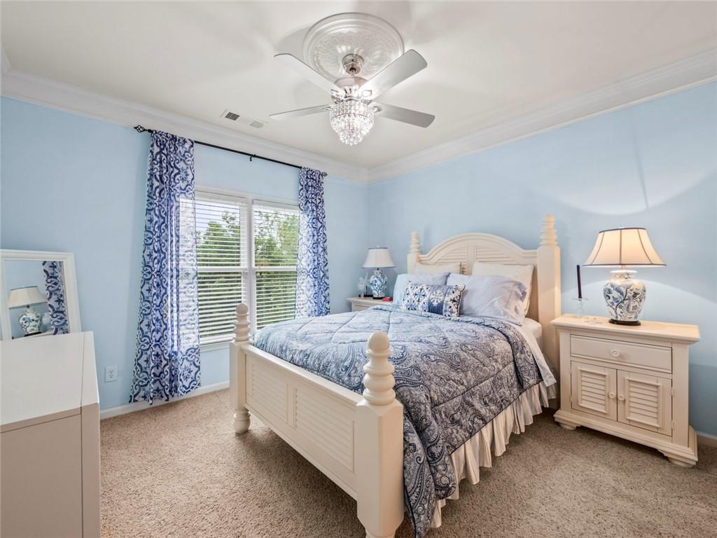 7060 Summit Ridge Chase Cumming, GA 30041 - Photo 25 of 58 a bed sitting in a bedroom next to a window