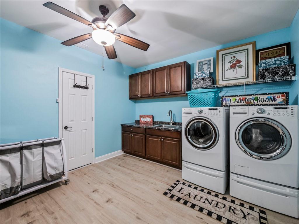 7060 Summit Ridge Chase Cumming, GA 30041 - Photo 28 of 58 a kitchen with stainless steel appliances granite countertop a stove a washer and dryer