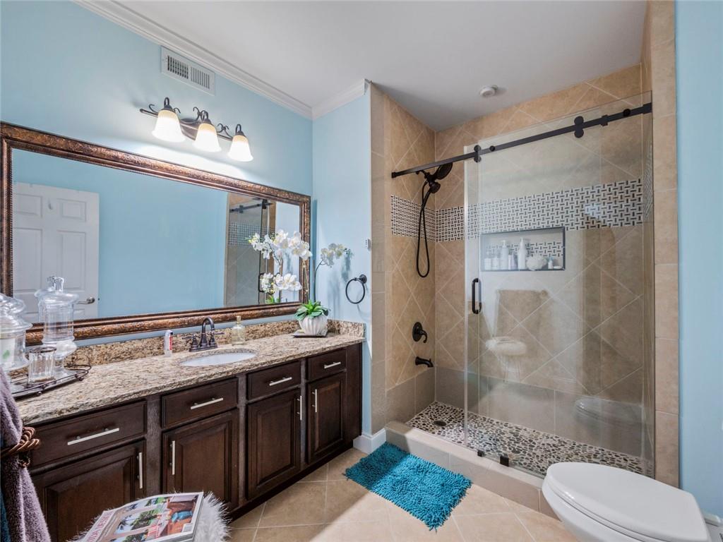 7060 Summit Ridge Chase Cumming, GA 30041 - Photo 30 of 58 a bathroom with a double vanity sink toilet mirror and shower