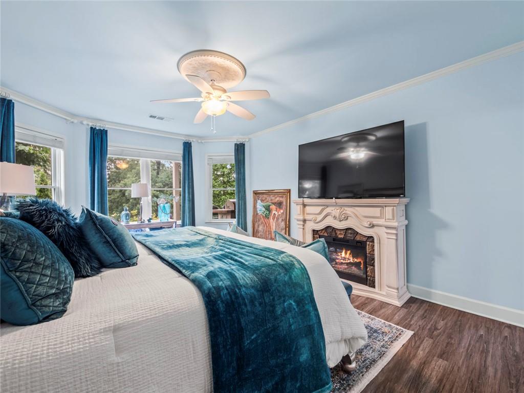 7060 Summit Ridge Chase Cumming, GA 30041 - Photo 32 of 58 a spacious bedroom with a bed and a flat screen tv