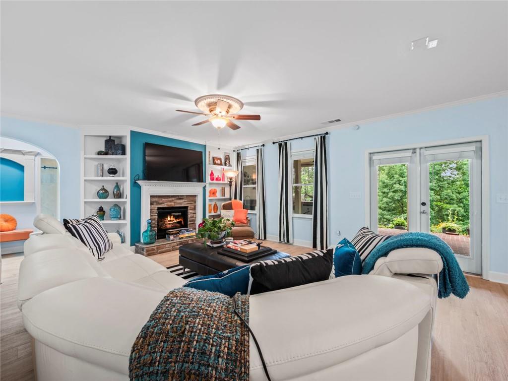 7060 Summit Ridge Chase Cumming, GA 30041 - Photo 35 of 58 a living room with furniture a fireplace and a flat screen tv