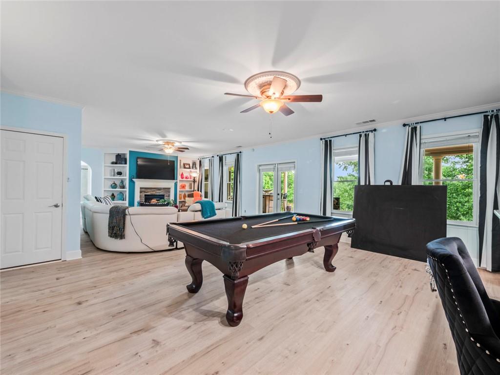 7060 Summit Ridge Chase Cumming, GA 30041 - Photo 36 of 58 a living room with furniture a flat screen tv and kitchen view
