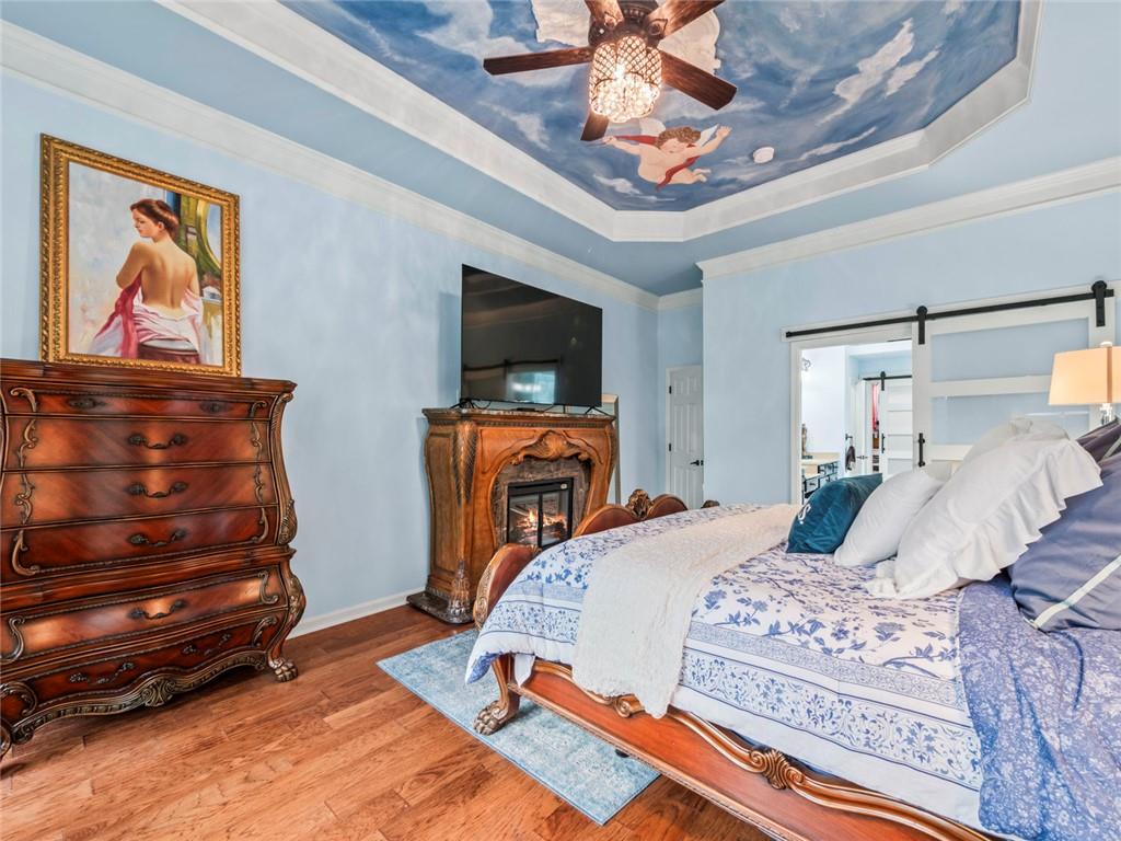 7060 Summit Ridge Chase Cumming, GA 30041 - Photo 41 of 58 a bedroom with a bed dresser and a flat screen tv