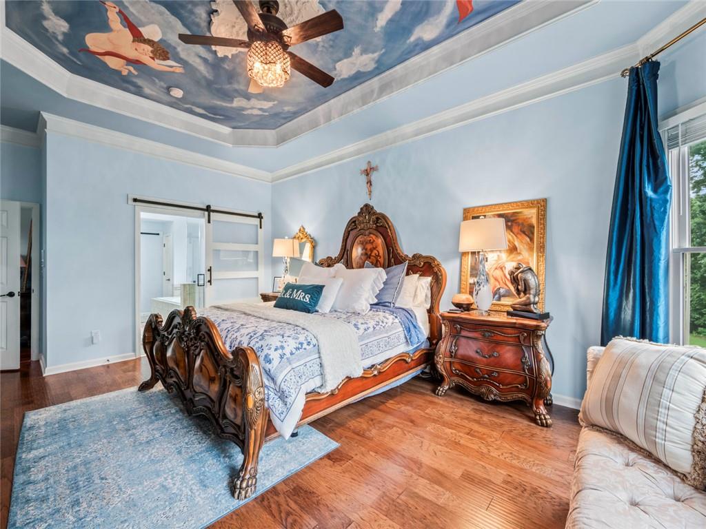 7060 Summit Ridge Chase Cumming, GA 30041 - Photo 42 of 58 a bed room with a bed and a chandelier