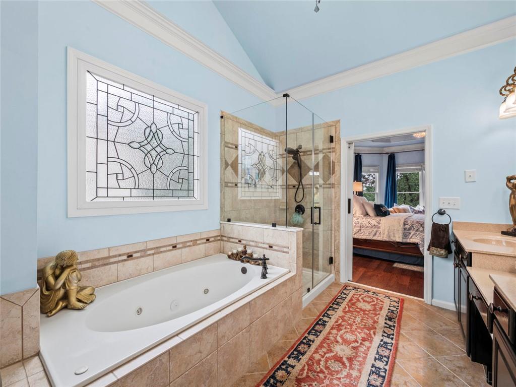 7060 Summit Ridge Chase Cumming, GA 30041 - Photo 44 of 58 a bathroom with a tub a sink and a window
