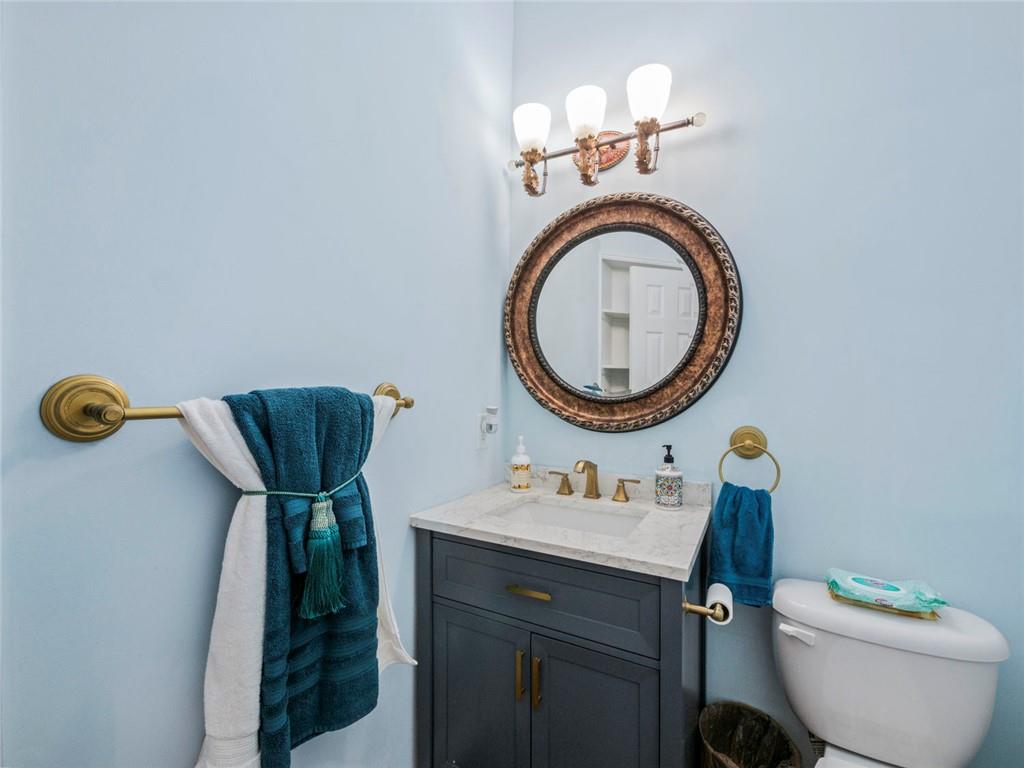 7060 Summit Ridge Chase Cumming, GA 30041 - Photo 45 of 58 a bathroom with a toilet mirror vanity and a sink